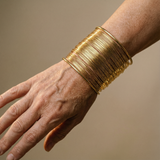 Open bracelet with gold spiral