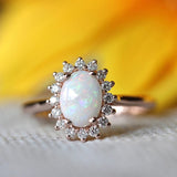 Vintage rose gold ring with oval opal and radiant crystal edge