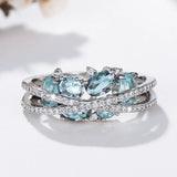 Silver ring with cross and blue gemstone
