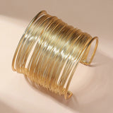 Open bracelet with gold spiral
