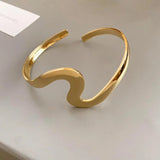 Classic open bracelet with golden wave