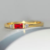 Golden red central stone and sparkling ring